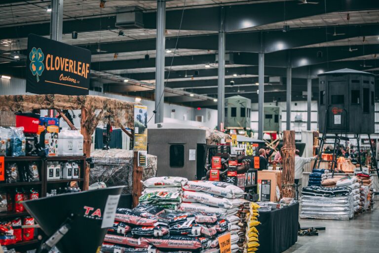 Overview of Cloverleaf Outdoors and other exhibitor booths displaying hunting and outdoor products at the Midwest Sportsmen Classic in Shipshewana.