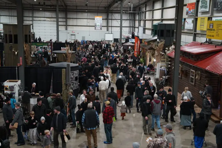 Aerial view of the busy expo floor plan at the Midwest Sportsmen Classic, showing crowds and various exhibitor booths.